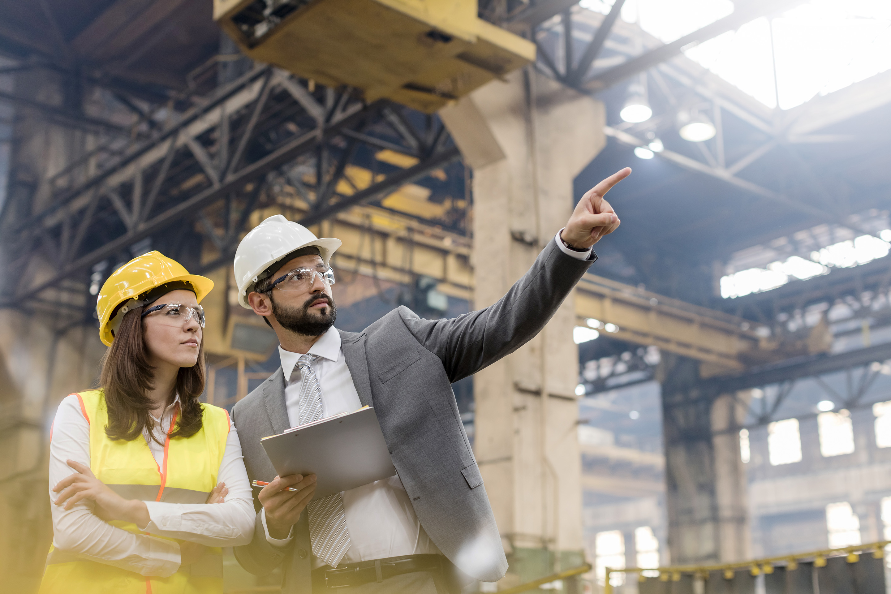 Manufacturing employees assessing equipment on a factory floor